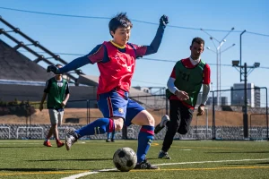 man kicking futsal ball Sports photography