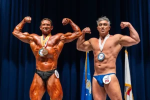 2 male bodybuilders double biceps pose
