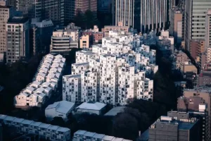 Intricate Tokyo City View showcasing a unique modular white geometric building complex among modern skyscrapers.