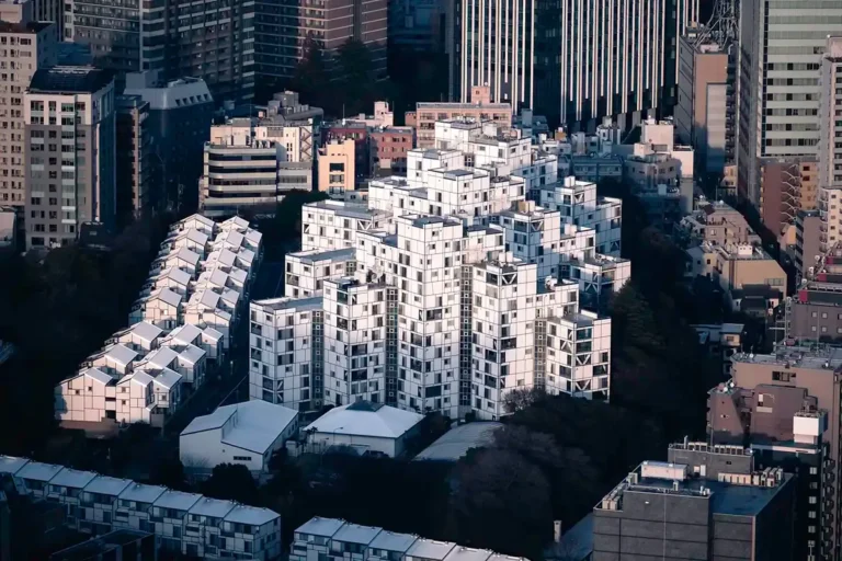 Intricate Tokyo City View showcasing a unique modular white geometric building complex among modern skyscrapers.